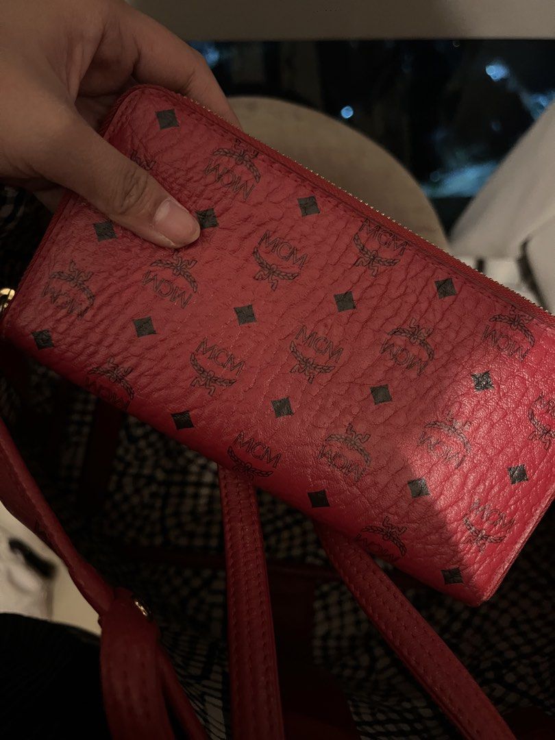 MCM Red Leather Monogram Zip Around Wallet (Category: Activewear) located in Imus. Submitted by ann__xoxo (Listing ID 1471180442, Image 1). Description: - Brand: MCM - Material: Premium red leather with classic all-over monogram print - Closure: Zip-around to keep cash and cards secure - Hardware: Elegant gold-tone zippers - Interior: Stylish red and black gingham lining - Condition: Clean exterior, well-maintained.