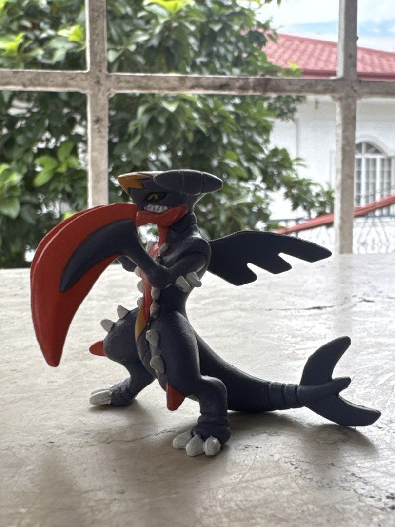 Mega Garchomp Pokémon Tomy Figure (Category: Figurines & Statues) located in Quezon City. Submitted by JDC_Onlineshop (Listing ID 1471145171, Image 2). Description: - Official Tomy Mega Garchomp figure - Detailed dark grey body with iconic red scythe arms and spiky accents - Stamped with authentic Pokémon and Tomy logos on the tail - Stands securely and independently on its feet and tail - Clean paint job with well-maintained details - Ideal for 