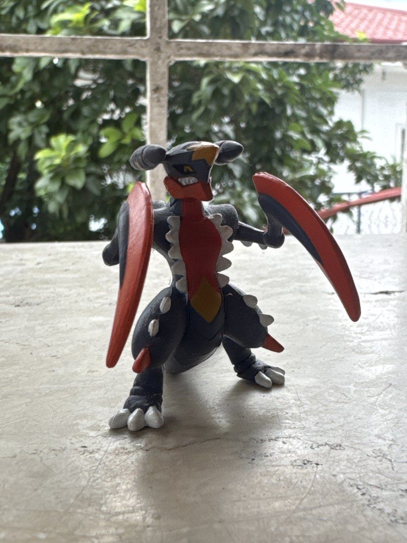 Mega Garchomp Pokémon Tomy Figure (Category: Figurines & Statues) located in Quezon City. Submitted by JDC_Onlineshop (Listing ID 1471145171, Image 1). Description: - Official Tomy Mega Garchomp figure - Detailed dark grey body with iconic red scythe arms and spiky accents - Stamped with authentic Pokémon and Tomy logos on the tail - Stands securely and independently on its feet and tail - Clean paint job with well-maintained details - Ideal for 