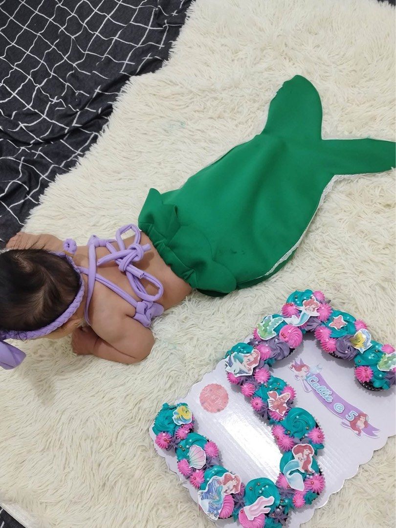 Mermaid Milestones costume (Category: Babies & Kids Fashion) located in San Mateo. Submitted by andra.dc (Listing ID 1471122130, Image 2). Description: - Adorable mermaid costume set for baby milestones and photoshoots - Includes a purple halter crop top, matching bow headband, and green mermaid tail skirt with white lace trim - Made with soft fabric that is easy to put on - Worn only once for a monthly birthday shoot.