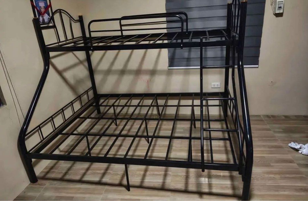 Metal Twin Over Full Bunk Bed Frame (Category: Bed Frames & Mattresses) located in Manila. Submitted by nique777 (Listing ID 1471175226, Image 1). Description: - Space-saving double-decker design ideal for shared bedrooms or guest rooms - Sturdy tubular steel construction in a clean matte black finish - Single-size top bunk and full-size lower mattress base - Includes built-in ladder and secure slatted supports for both levels - Easy to disassemb