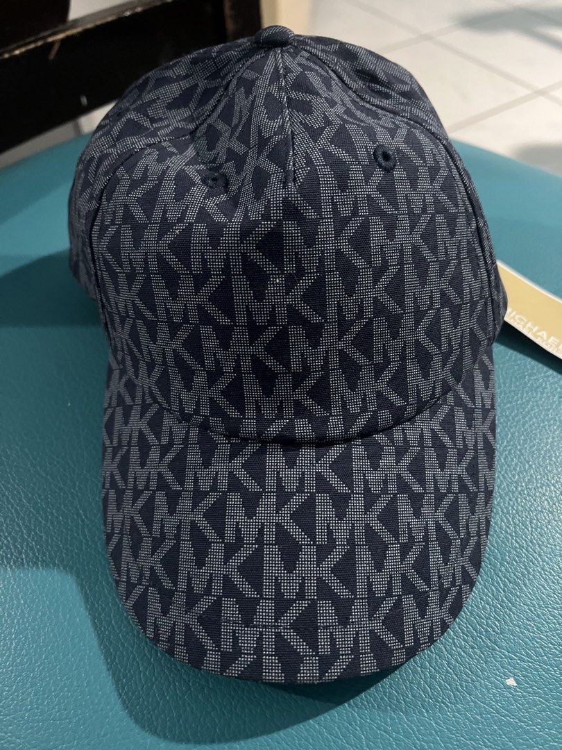 Michael Kors MK Monogram Baseball Cap Blue (Category: Caps & Hats) located in Manila. Submitted by aiguuurl165091 (Listing ID 1471248021, Image 1). Description: - Brand: Michael Kors - Color: Dark Blue with all-over MK monogram print - Size: One Size (Adjustable strap with metal hardware for a custom fit) - Condition: Brand new with tag - Details: Interior branding tape on sweatband and branded gold inner seam label - 100% Authentic and ready to 