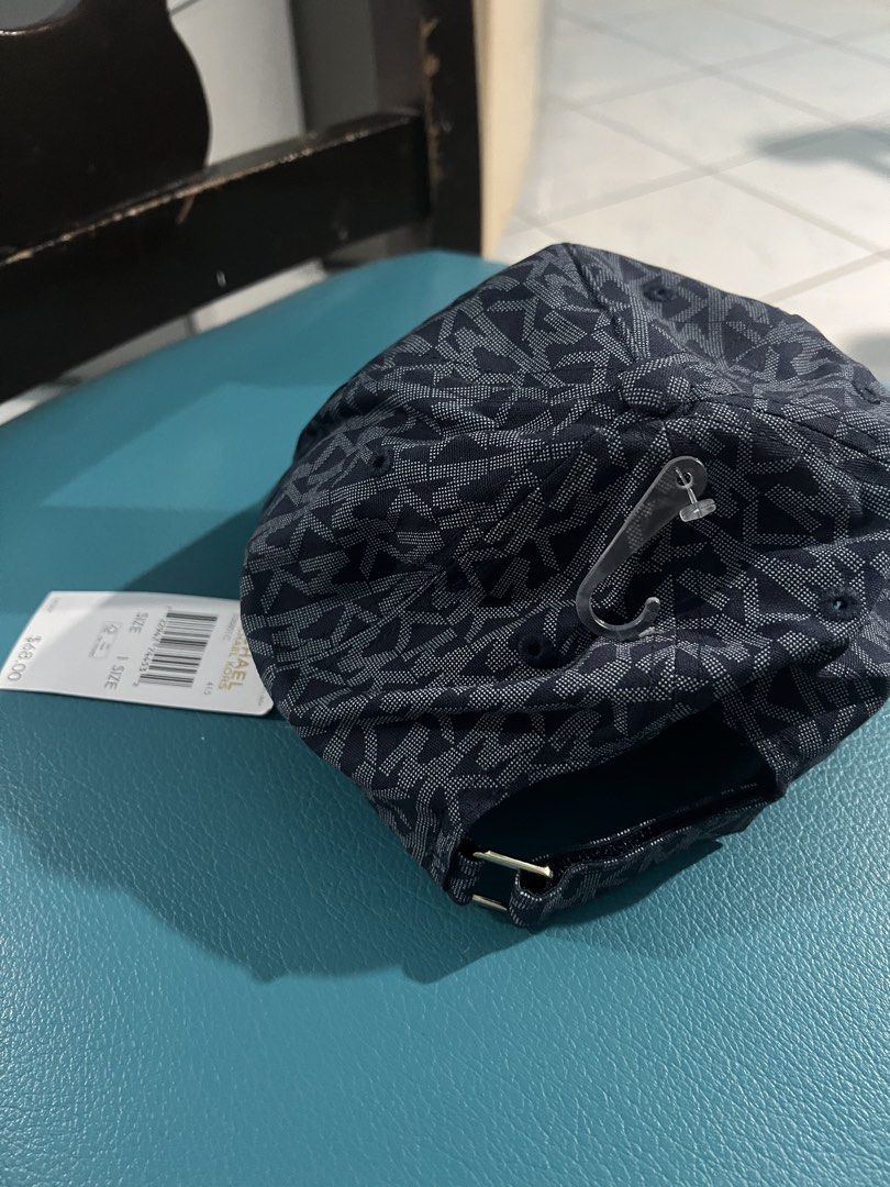 Michael Kors MK Monogram Baseball Cap Blue (Category: Caps & Hats) located in Manila. Submitted by aiguuurl165091 (Listing ID 1471248021, Image 2). Description: - Brand: Michael Kors - Color: Dark Blue with all-over MK monogram print - Size: One Size (Adjustable strap with metal hardware for a custom fit) - Condition: Brand new with tag - Details: Interior branding tape on sweatband and branded gold inner seam label - 100% Authentic and ready to 