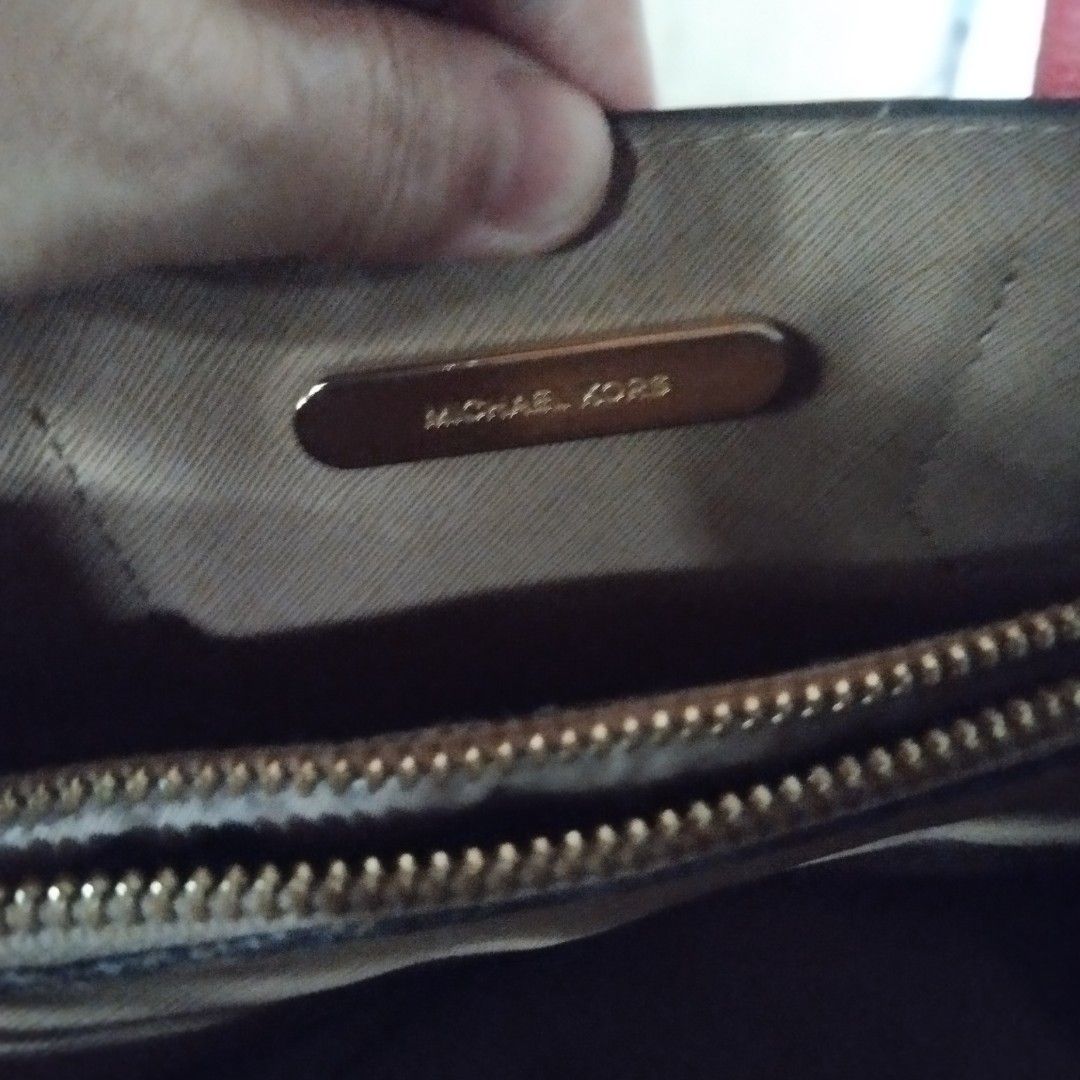 Michael Kors Red Leather Tote Bag (Category: Tote Bags) located in Manila. Submitted by lene48 (Listing ID 1471139978, Image 3). Description: - Brand: Michael Kors - Color: Bright red - Material: Pebbled leather with gold-tone hardware - Straps: Dual top carry handles and matching adjustable shoulder strap - Closure: Secure zipper closure - Interior: Clean fabric lining with signature logo plate tag - Condition: Clean inside and out, ready to use