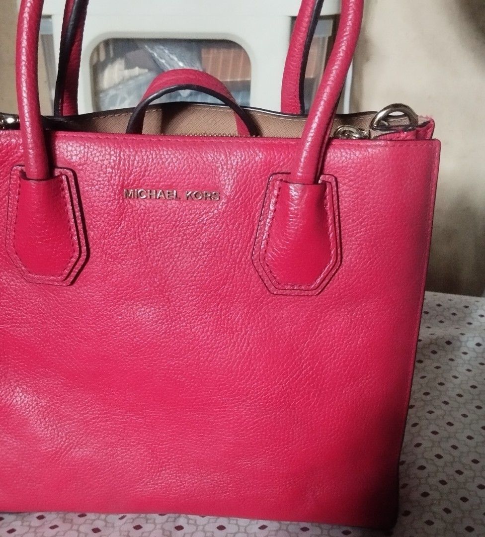 Michael Kors Red Leather Tote Handbag (Category: Tote Bags) located in Manila. Submitted by lene48 (Listing ID 1471224268, Image 2). Description: - Vibrant bright red pebble leather exterior with sleek gold hardware - Secure double top handles and central zippered compartment - Clean beige fabric lining with an embossed metal logo plaque - Durable protective metal feet on the bottom base - Perfect pop of color for any outfitflaw last pic. .