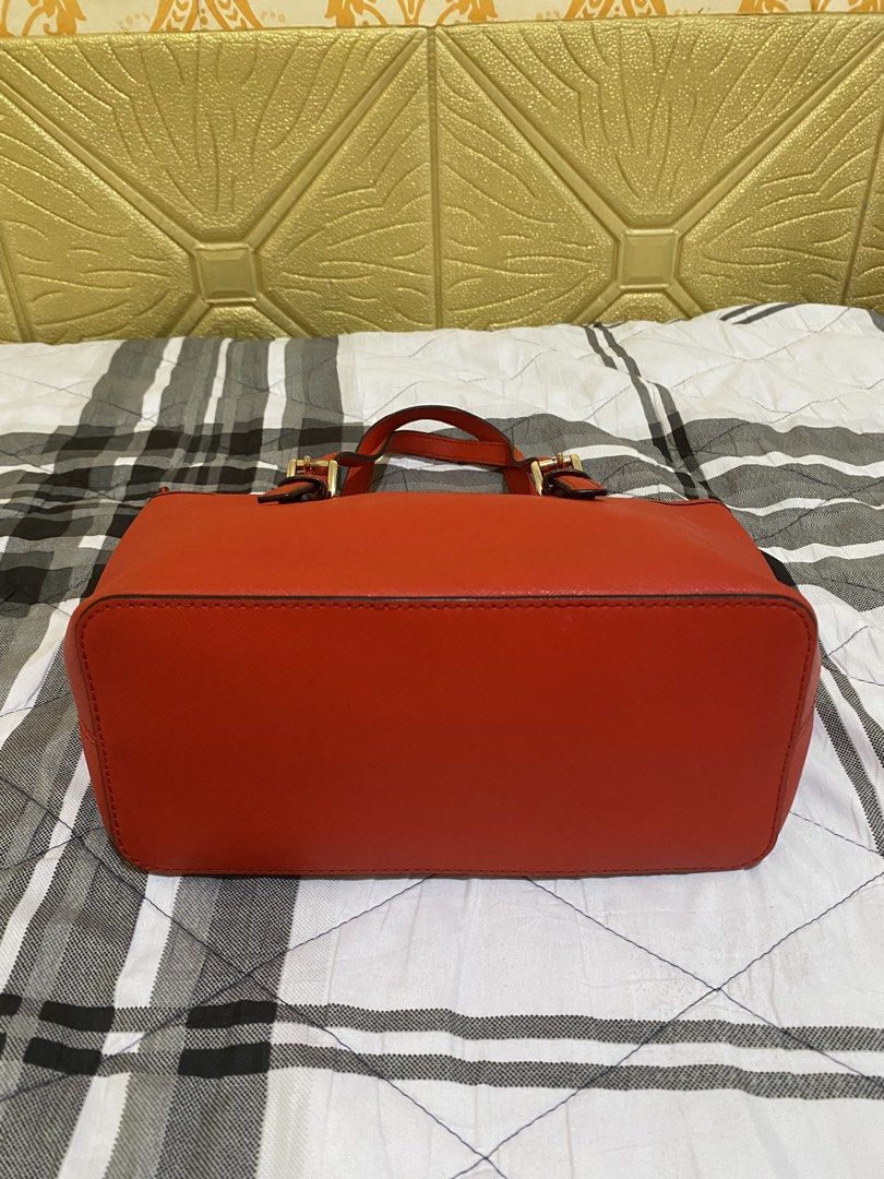Michael Kors Red Saffiano Leather Tote Bag (Category: Tote Bags) located in Pasay City. Submitted by honey.gee11 (Listing ID 1471171701, Image 3). Description: - Authentic Michael Kors bright red handbag in structured Saffiano leather - Elegant gold-tone hardware and front logo lettering - Dual top carry handles and secure top zip closure - Exterior back slip pocket for easy access - Clean interior featuring zipper and slip compartments - Structu