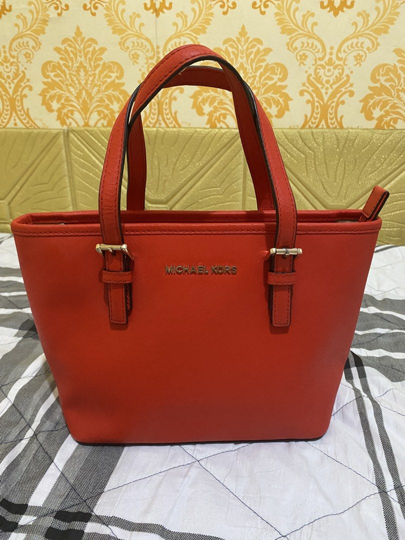 Michael Kors Red Saffiano Leather Tote Bag (Category: Tote Bags) located in Pasay City. Submitted by honey.gee11 (Listing ID 1471171701, Image 1). Description: - Authentic Michael Kors bright red handbag in structured Saffiano leather - Elegant gold-tone hardware and front logo lettering - Dual top carry handles and secure top zip closure - Exterior back slip pocket for easy access - Clean interior featuring zipper and slip compartments - Structu