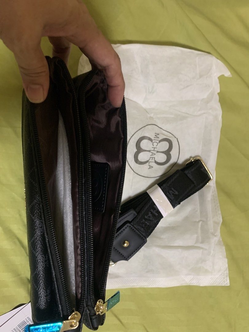 MICHAELA Black Pattern Crossbody Bag with Strap (Category: Cross-body Bags) located in Manila. Submitted by angelyrrehc (Listing ID 1471142076, Image 2). Description: - Brand: MICHAELA - Color: Black with repeating diamond logo pattern & gold-tone hardware - Size: 10x6x1.5inches - Condition: Brand new with original tags (including SM store price tag) and dust bag - Strap: Detachable black branded strap - Storage: Multiple zipped compartments & fr