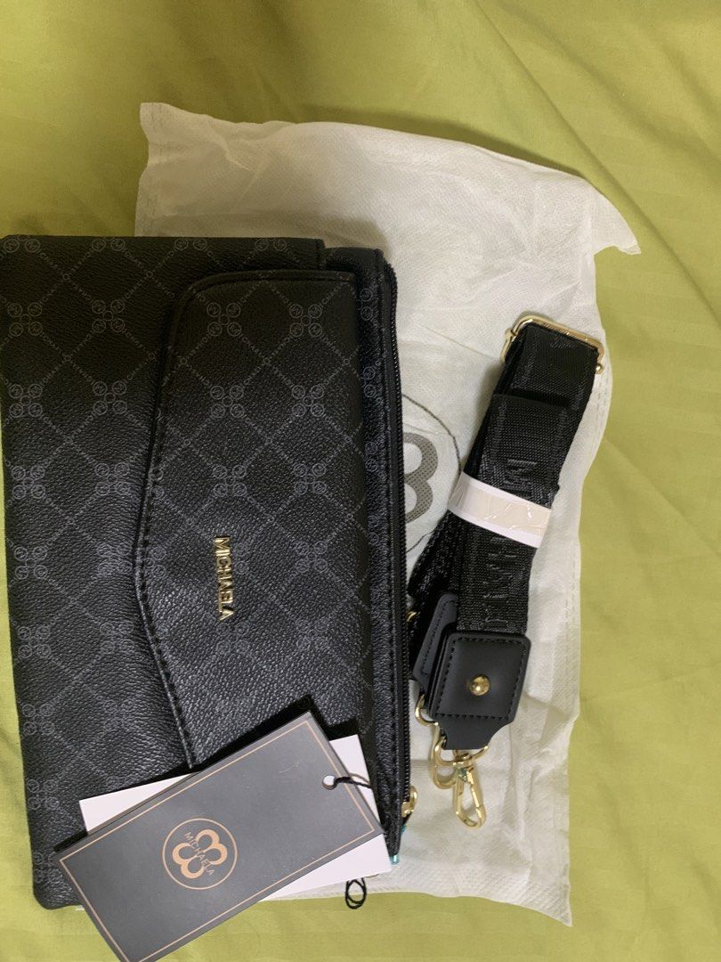 MICHAELA Black Pattern Crossbody Bag with Strap (Category: Cross-body Bags) located in Manila. Submitted by angelyrrehc (Listing ID 1471142076, Image 1). Description: - Brand: MICHAELA - Color: Black with repeating diamond logo pattern & gold-tone hardware - Size: 10x6x1.5inches - Condition: Brand new with original tags (including SM store price tag) and dust bag - Strap: Detachable black branded strap - Storage: Multiple zipped compartments & fr