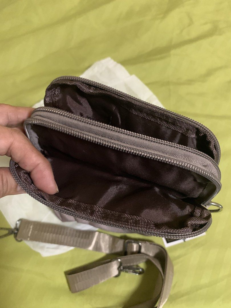 Michaela multi-compartment sling bag with adjustable strap (Category: Cross-body Bags) located in Manila. Submitted by angelyrrehc (Listing ID 1471142956, Image 2). Description: - Brand: Michaela - Color: Dusty mauve brown - Compartments: Multiple zippered compartments inside and out for maximum organization - Strap: Adjustable and detachable golden-beige strap - Details: Front pocket with a stylish metal brand logo emblem - Inclusions: Comes wit