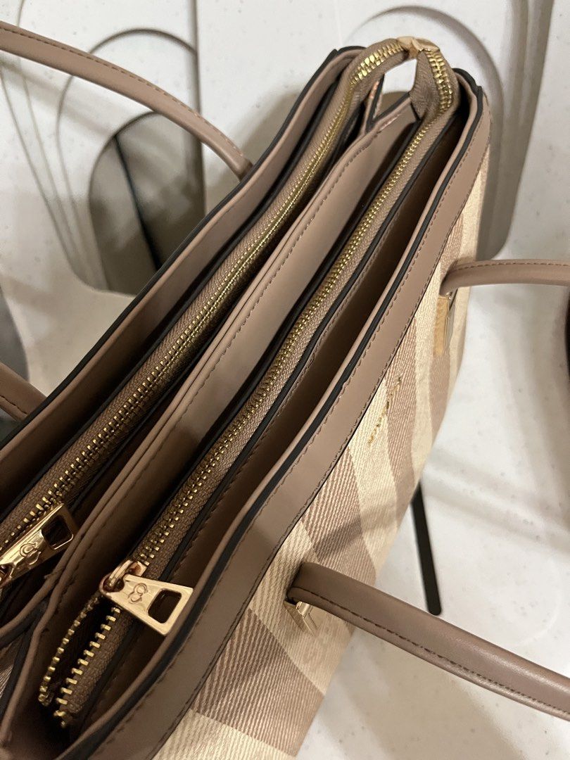 MICHAELA Striped Tote Bag Brown Beige (Category: Tote Bags) located in Koronadal. Submitted by hiiiii.hello (Listing ID 1471130923, Image 3). Description: - Color: Classic brown and beige stripes - Hardware: Elegant gold-toned details - Straps: Sturdy and comfortable for shoulder wear - Interior: Multiple zippered compartments for easy organization - Lining: Clean fabric with stylish logo prints.