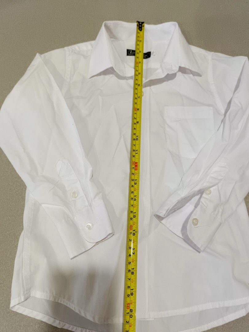 Mini World White Long Sleeve Button Down Shirt Size 120 (Category: Babies & Kids Fashion) located in Santa Rosa. Submitted by chindeclutters (Listing ID 1471258346, Image 3). Description: - Brand: Mini World - Size: 120/60 - Color: Classic solid white - Material: Clean and comfortable cotton - Features: Standard collar, single left chest pocket, button cuffs, and plain back - Ideal for: School uniforms and formal occasions - bought at sm - used f