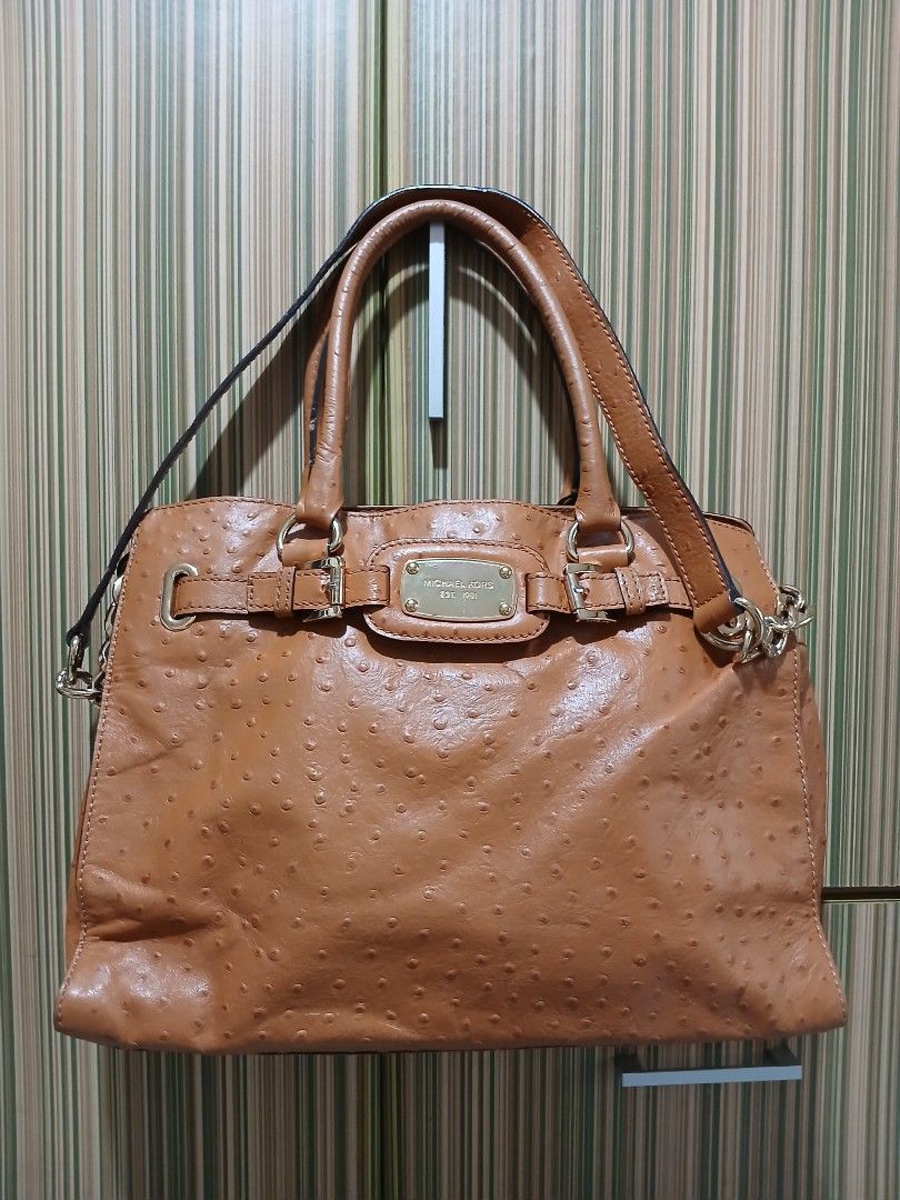 MK Tan Ostrich Leather Shoulder Bag (Category: Luxury Bags & Wallets) located in Taguig. Submitted by demsclosetph (Listing ID 1471185369, Image 1). Description: - Brand: Michael Kors - Material: Tan ostrich-embossed leather with gold-tone hardware - Hardware: Engraved front logo plaque and protective metal feet on the base - Straps: Dual top handles and a detachable strap with chic chain-link accents - Closure: Secure top zipper closure - Interi