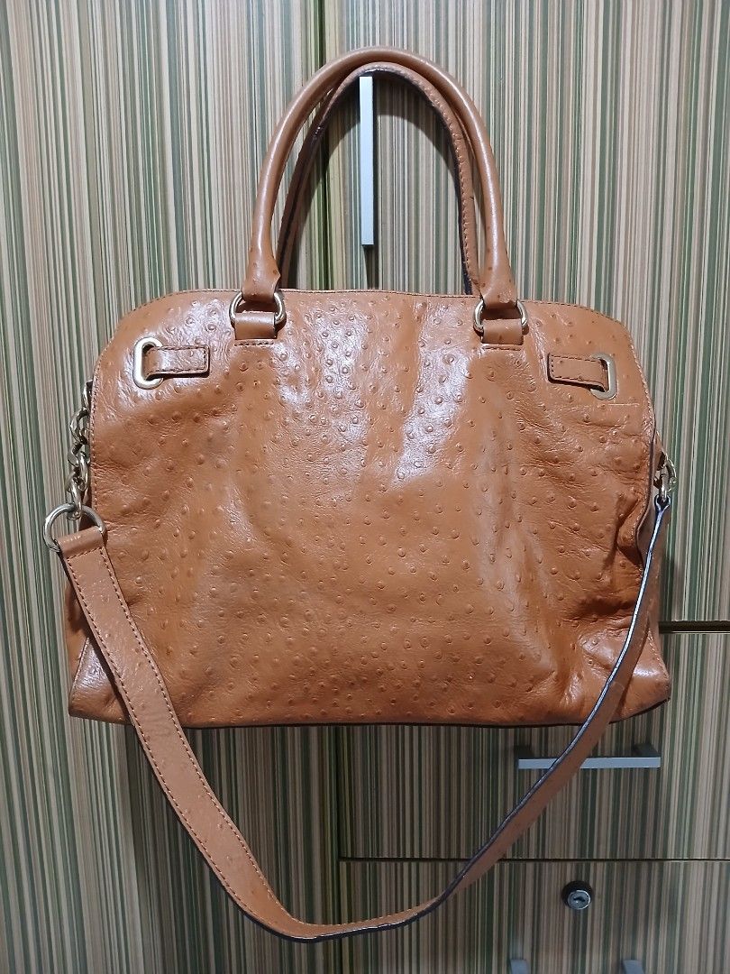 MK Tan Ostrich Leather Shoulder Bag (Category: Luxury Bags & Wallets) located in Taguig. Submitted by demsclosetph (Listing ID 1471185369, Image 2). Description: - Brand: Michael Kors - Material: Tan ostrich-embossed leather with gold-tone hardware - Hardware: Engraved front logo plaque and protective metal feet on the base - Straps: Dual top handles and a detachable strap with chic chain-link accents - Closure: Secure top zipper closure - Interi