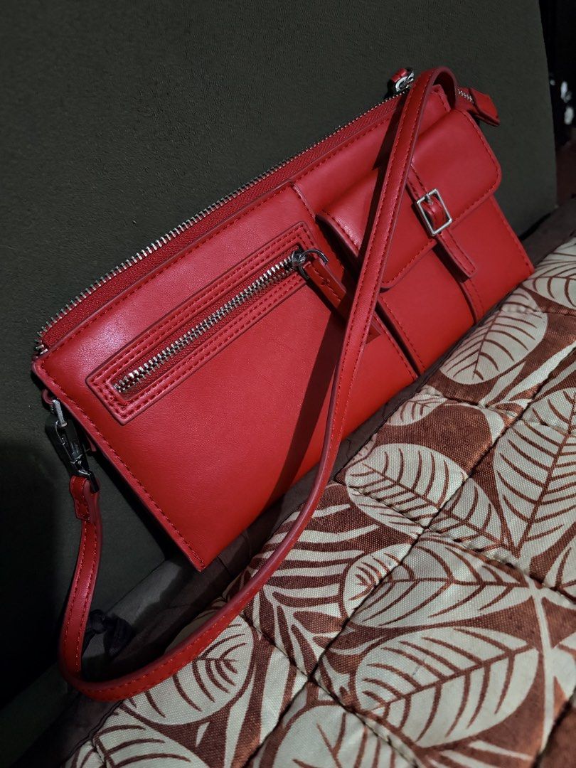 MNG Red Crossbody Bag (Category: Cross-body Bags) located in Manila. Submitted by sereenity (Listing ID 1471229148, Image 2). Description: - Brand: MNG - Color: Bright red - Condition: Brand new with tag attached inside - Closure: Secure top zipper - Pockets: Exterior zip pocket and stylish buckle pouch flap - Strap: Adjustable shoulder strap - Interior: Red fabric lining with multiple compartments and stitched brand logo.