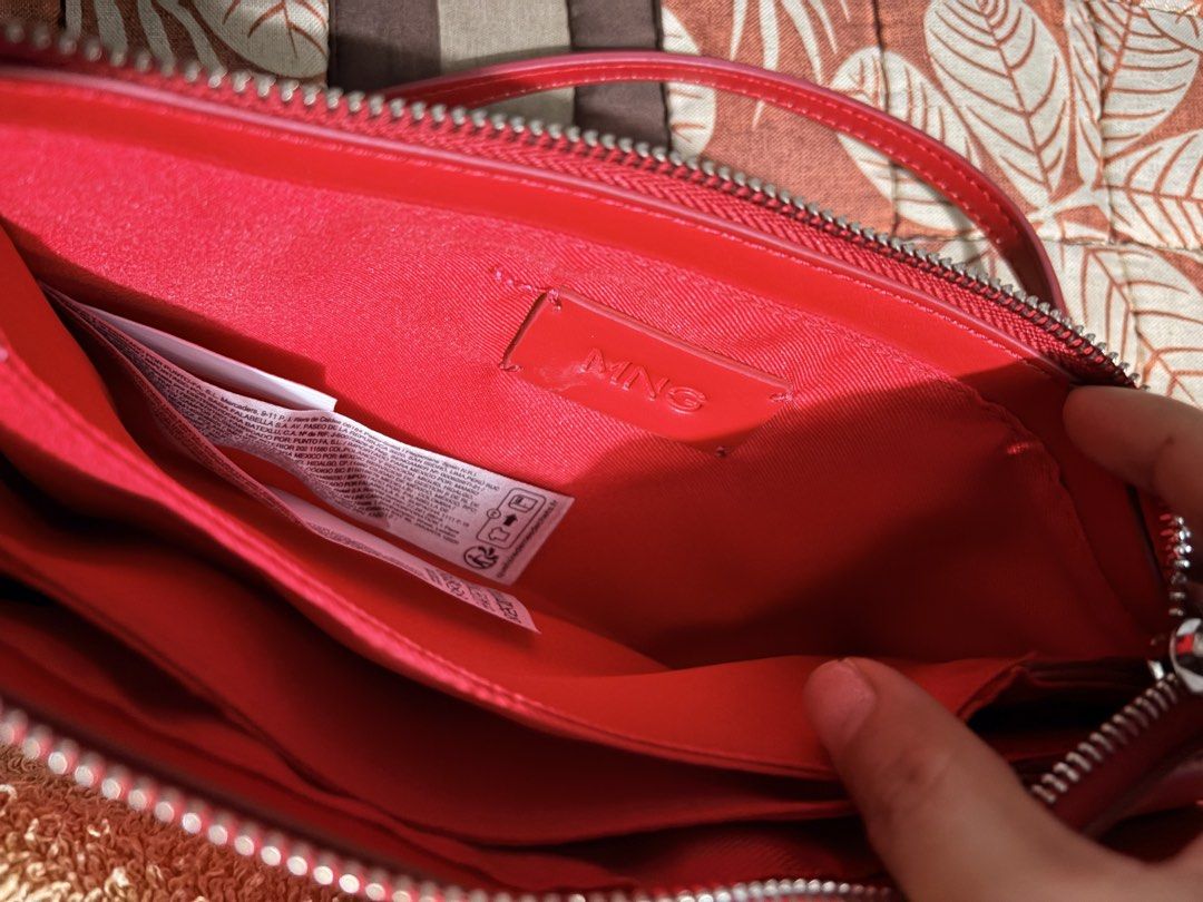 MNG Red Crossbody Bag (Category: Cross-body Bags) located in Manila. Submitted by sereenity (Listing ID 1471229148, Image 3). Description: - Brand: MNG - Color: Bright red - Condition: Brand new with tag attached inside - Closure: Secure top zipper - Pockets: Exterior zip pocket and stylish buckle pouch flap - Strap: Adjustable shoulder strap - Interior: Red fabric lining with multiple compartments and stitched brand logo.