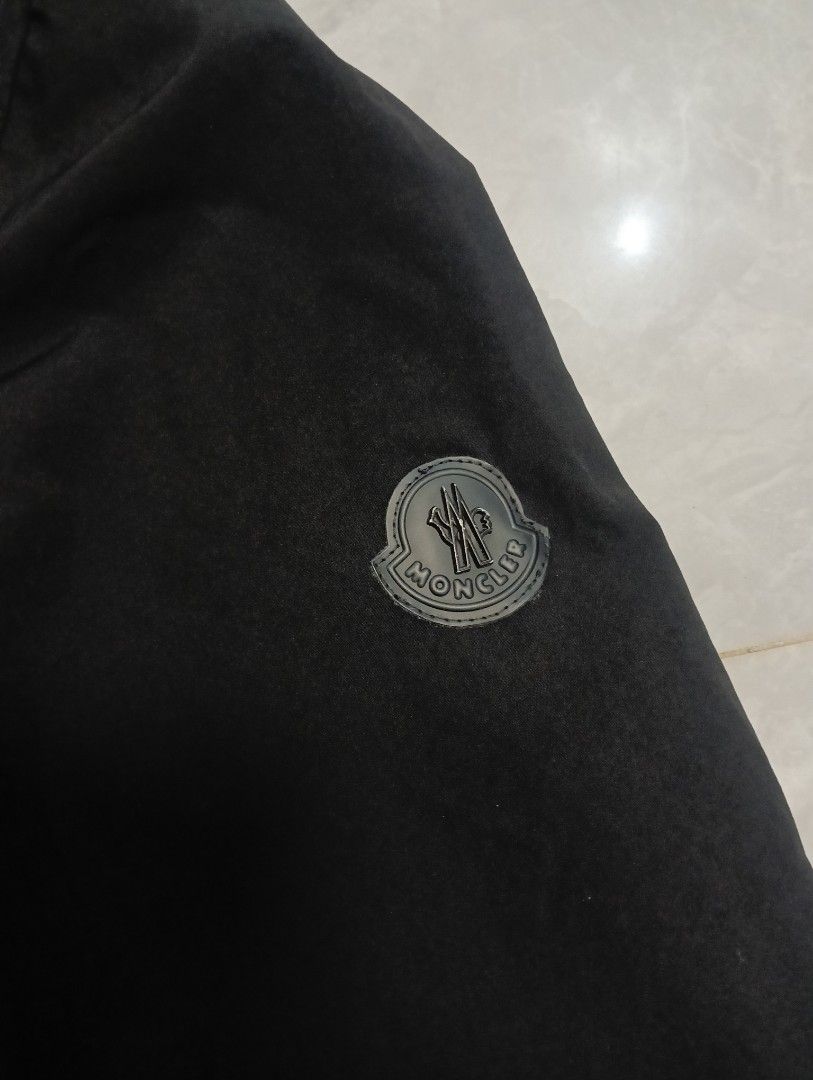 Moncler Black Hooded Zip Jacket (Category: Coats, Jackets and Outerwear) located in Odiongan. Submitted by thrifthub_bundang07 (Listing ID 1471247184, Image 2). Description: - Brand: Moncler - Color: Black with iconic red, white, and blue stripe details - Material: 100% comfortable cotton - Features: Zip pockets, sleeve logo patch, and adjustable drawstrings at hood and bottom hem - Condition: Excellent, well-maintained - Mode of Payment: GCash, 