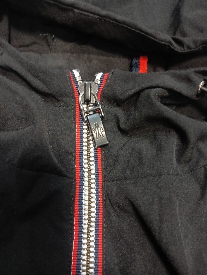 Moncler Black Hooded Zip Jacket (Category: Coats, Jackets and Outerwear) located in Odiongan. Submitted by thrifthub_bundang07 (Listing ID 1471247184, Image 3). Description: - Brand: Moncler - Color: Black with iconic red, white, and blue stripe details - Material: 100% comfortable cotton - Features: Zip pockets, sleeve logo patch, and adjustable drawstrings at hood and bottom hem - Condition: Excellent, well-maintained - Mode of Payment: GCash, 