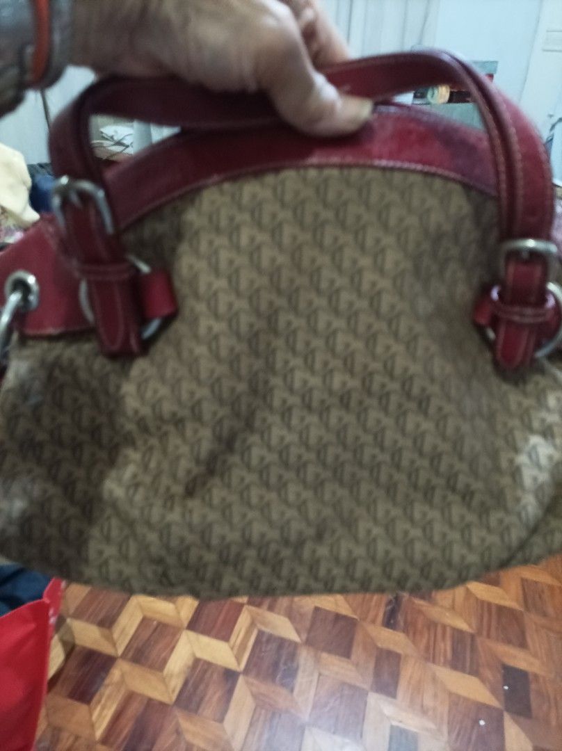 Monogram Pattern Handbag with Red Leather Trim (Category: Luxury Bags & Wallets) located in Quezon City. Submitted by fidodem (Listing ID 1471219017, Image 2). Description: - Authentic brown fabric tote with stylish all-over monogram pattern - Eye-catching red leather trim and structured top grab handles - Sleek silver-tone hardware featuring decorative buckle strap details - Secure zip top closure to keep your belongings safe - Spacious fabric-l