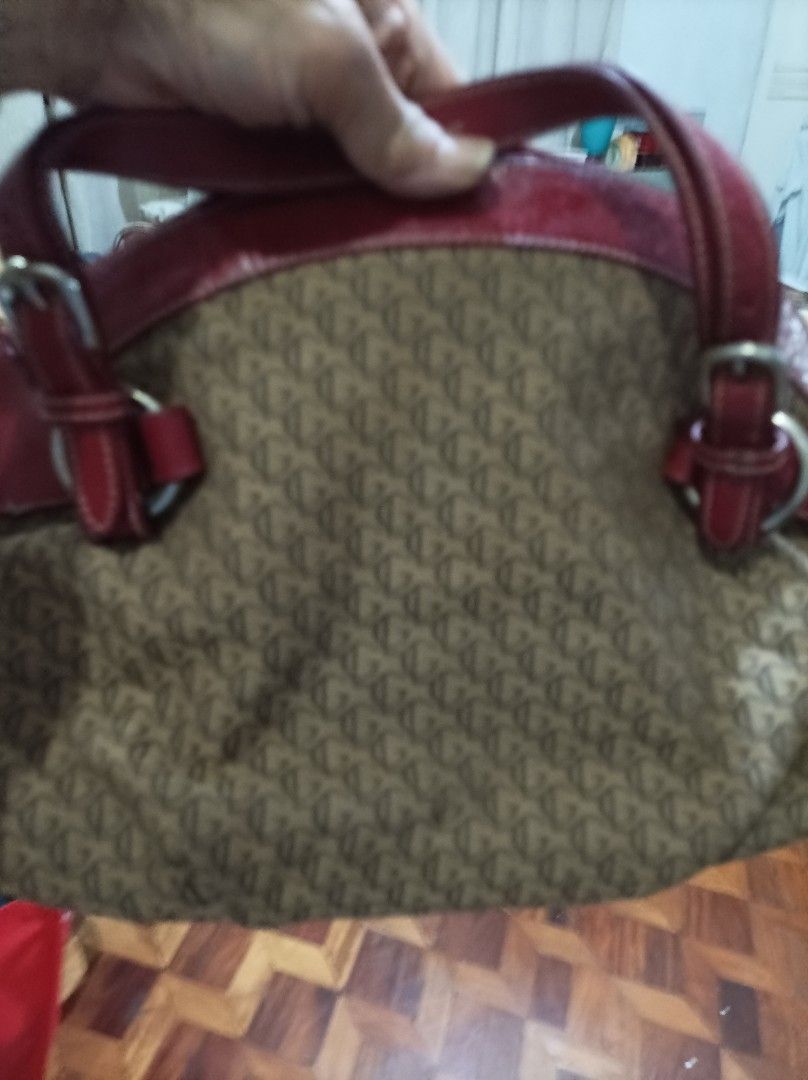 Monogram Pattern Handbag with Red Leather Trim (Category: Luxury Bags & Wallets) located in Quezon City. Submitted by fidodem (Listing ID 1471219017, Image 1). Description: - Authentic brown fabric tote with stylish all-over monogram pattern - Eye-catching red leather trim and structured top grab handles - Sleek silver-tone hardware featuring decorative buckle strap details - Secure zip top closure to keep your belongings safe - Spacious fabric-l
