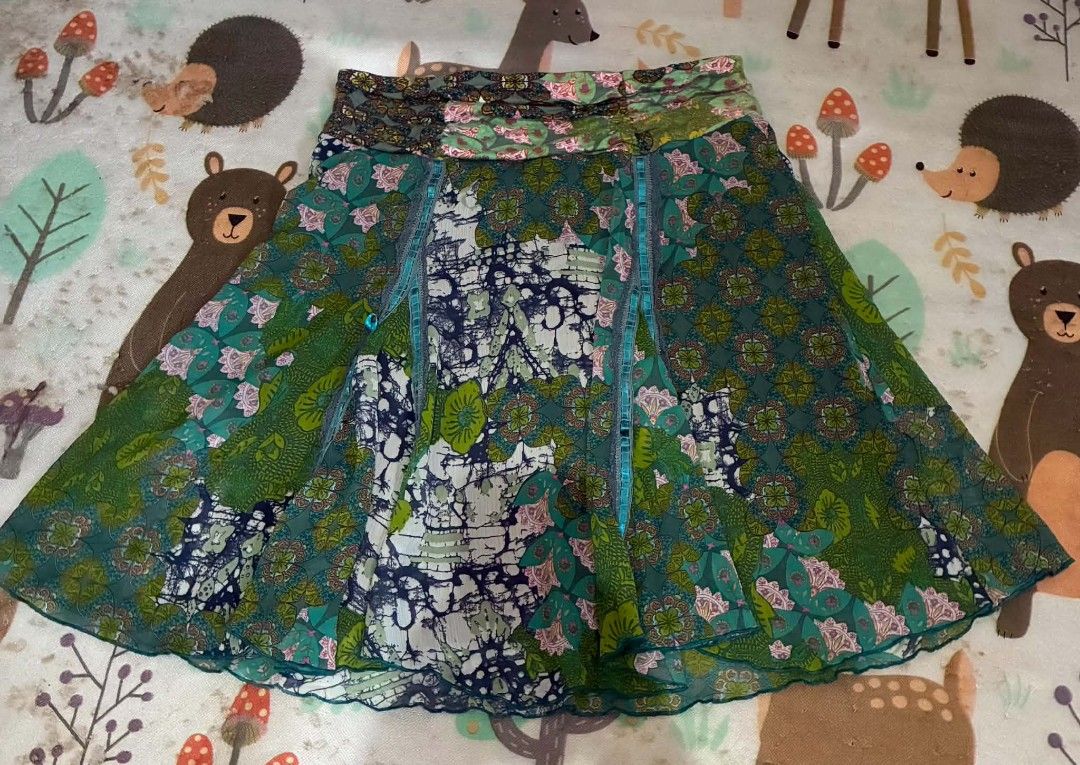Morgan de Toi Floral Patchwork Printed Flare Skirt (Category: Skirts) located in Nabunturan. Submitted by kairosas85 (Listing ID 1471294551, Image 2). Description: - Brand: Morgan de Toi - Style: Green patterned midi skirt with unique multi-panel design - Print: Mix of floral and abstract patterns all over - Comfort: Lightweight fabric with an olive green inner lining and stretchy elastic waistband - Styling: Easy to pair with basic tops for a ch