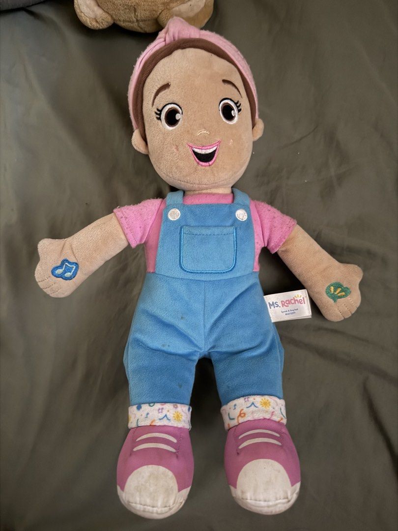 Ms. Rachel Speak and Sing Doll (Category: Plushies & Soft Toys) located in Quezon City. Submitted by shopcjv (Listing ID 1471225863, Image 1). Description: - Official Ms. Rachel Speak and Sing Doll in her classic pink shirt and blue overalls - Features brown hair in a ponytail with a pink headband and interactive hand symbols - Includes original side fabric tag - Condition note: Some minor fuzziness on the pink sleeves - Smoke-free and pet-free h
