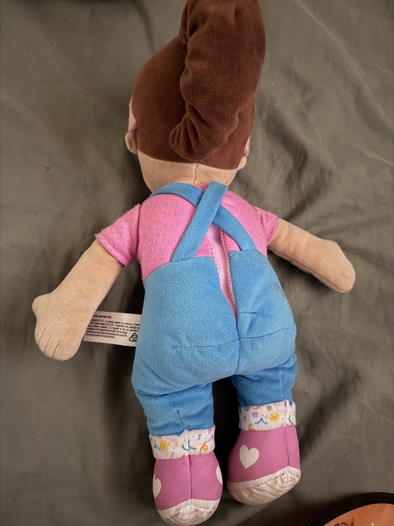 Ms. Rachel Speak and Sing Doll (Category: Plushies & Soft Toys) located in Quezon City. Submitted by shopcjv (Listing ID 1471225863, Image 2). Description: - Official Ms. Rachel Speak and Sing Doll in her classic pink shirt and blue overalls - Features brown hair in a ponytail with a pink headband and interactive hand symbols - Includes original side fabric tag - Condition note: Some minor fuzziness on the pink sleeves - Smoke-free and pet-free h