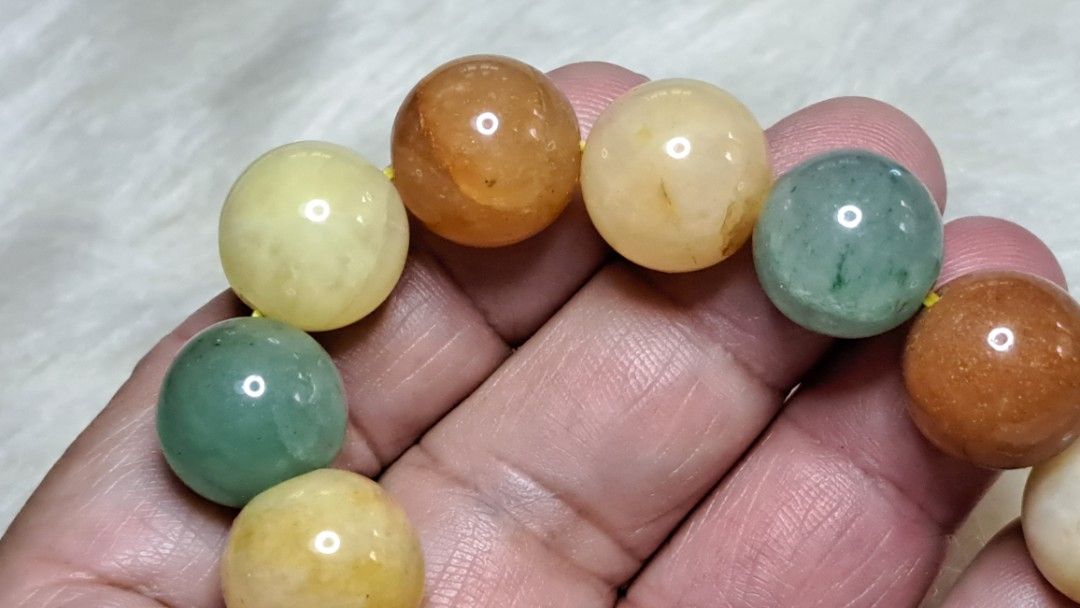Multicolor Natural Stone Beaded Bracelet (Category: Bracelets) located in Quezon City. Submitted by crystallinehaven (Listing ID 1471140868, Image 1). Description: - Material: Smooth polished natural gemstone beads - Colors: Mixed earth tones (green, orange, yellow, brown) - Fit: Standard stretch elastic fits most wrist sizes - Style: Versatile everyday beaded bracelet - Note: Coin in photos is for size reference only .