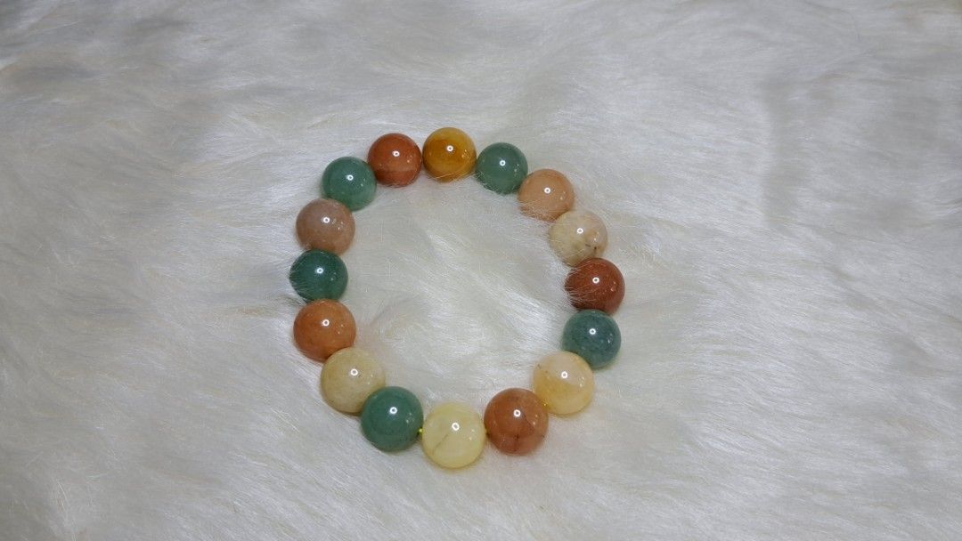 Multicolor Natural Stone Beaded Bracelet (Category: Bracelets) located in Quezon City. Submitted by crystallinehaven (Listing ID 1471140868, Image 3). Description: - Material: Smooth polished natural gemstone beads - Colors: Mixed earth tones (green, orange, yellow, brown) - Fit: Standard stretch elastic fits most wrist sizes - Style: Versatile everyday beaded bracelet - Note: Coin in photos is for size reference only .
