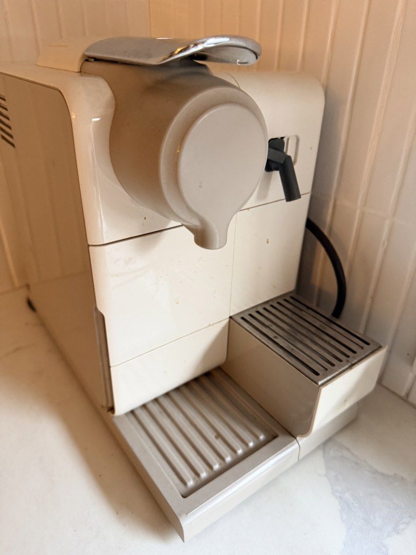 Nespresso Coffee Machine Latissima (Category: Coffee Machines & Makers) located in Quezon City. Submitted by shop_outlet (Listing ID 1471279958, Image 2). Description: - Color: Cream white -brand: nespresso - Features: Multiple cup size buttons, chrome lever handle - Inclusions: Standard drip tray and nozzle attachments - Reason for selling: Clearing out kitchen counter space - no issues.