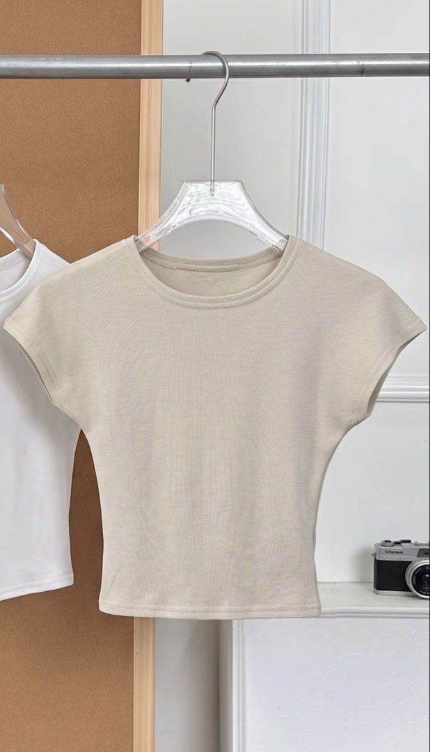 Neutral Beige Ribbed Short Sleeve Crop Top (Category: Shirts) located in Quezon City. Submitted by habits.mnl (Listing ID 1471160659, Image 1). Description: - Color: Neutral Beige - Fit: Snug, fitted silhouette crop top - Details: Short sleeves, round neckline, clean stitching on collar and hem - Texture: Soft ribbed fabric - Styling: Easy to pair with high-waisted denim, skirts, or shorts - Condition: Brand new / Great basic everyday staple.