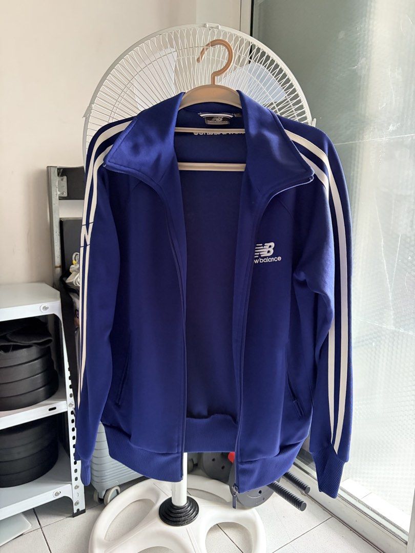 New Balance Track Jacket (Category: Coats, Jackets and Outerwear) located in Manila. Submitted by bndthetrnd (Listing ID 1471167595, Image 1). Description: - Brand: New Balance - Color: Royal blue with white accents - Style: Retro track jacket with racing stripes on sleeves - Features: Full front zip, high collar, ribbed cuffs and hem - Branding: Embroidered logo on chest and bold print on back collar - Condition: Clean and sporty - Best for: Wor
