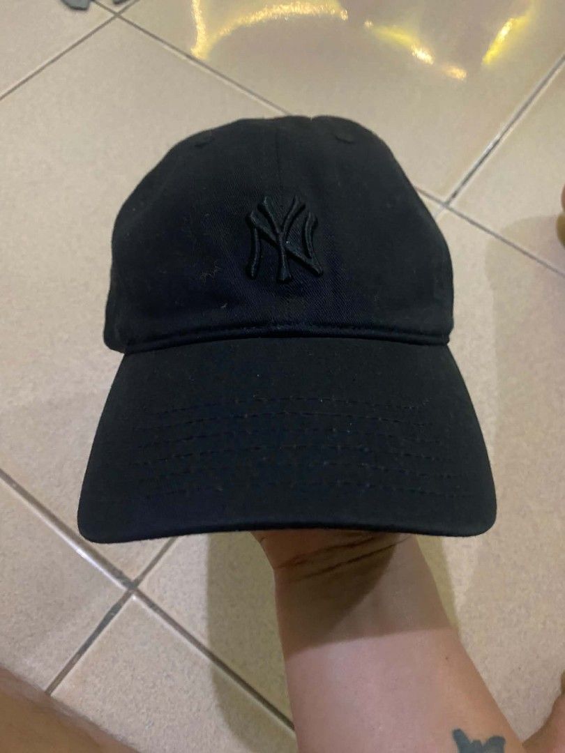 New York Yankees MLB Black Cap (Category: Caps & Hats) located in Quezon City. Submitted by elihur.tuazon (Listing ID 1471291394, Image 1). Description: - Color: Black - Team: New York Yankees - Style: Classic dad hat - Details: Embroidered NY logo on the front and MLB batter patch on the back - Material: 100% cotton - Fit: Adjustable strapback with metal buckle.