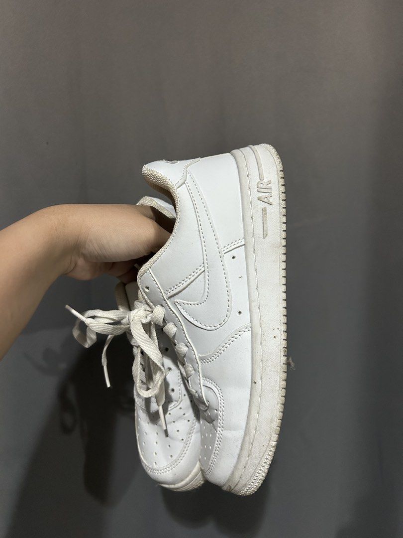 Nike Air Force 1 Low White (Category: Sneakers) located in Manila. Submitted by pett.apet (Listing ID 1471218351, Image 1). Description: - Item: White Nike Air Force 1 sneakers - Style: Classic low-top with lace-up fastening and perforated toe box - Sole: Chunky rubber sole with Air cushioning branding - Condition: Regular wear with minor dirt marks and scuffs on the midsoles - Inclusions: Comes with original red Nike shoebox.