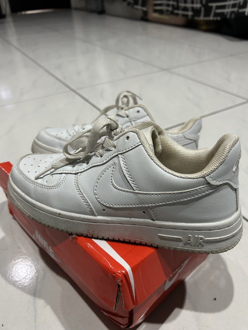 Nike Air Force 1 Low White (Category: Sneakers) located in Manila. Submitted by pett.apet (Listing ID 1471218351, Image 2). Description: - Item: White Nike Air Force 1 sneakers - Style: Classic low-top with lace-up fastening and perforated toe box - Sole: Chunky rubber sole with Air cushioning branding - Condition: Regular wear with minor dirt marks and scuffs on the midsoles - Inclusions: Comes with original red Nike shoebox.