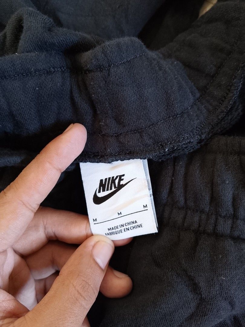 Nike Black Sweatpants Size M FB2728-010 (Category: Joggers) located in Baler. Submitted by vansonearth (Listing ID 1471131489, Image 3). Description: - Brand: Nike - Style: Black sweatpants with white swoosh logo - Size: Medium - Features: Adjustable drawstring waistband - Condition/Origin: Made in China, comfortable casual wear - Ideal for: Everyday lounging, errands, or workouts.