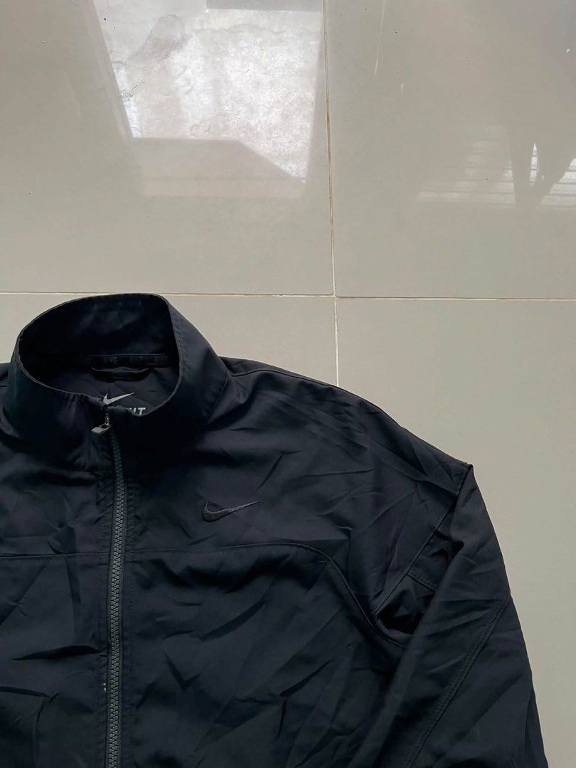 Nike Dri-FIT Black Zip Jacket Size L (Category: Coats, Jackets and Outerwear) located in Lapu Lapu. Submitted by trip-thrift (Listing ID 1471147038, Image 2). Description: Black Nike Dri-FIT zip-up jacket. High collar, full zipper front, zippered side pockets. Tonal swoosh embroidery on the chest. 100 percent polyester fabric. Size L on the tag, fits height 170 to 180 cm. Great lightweight layer for workouts or casual wear..