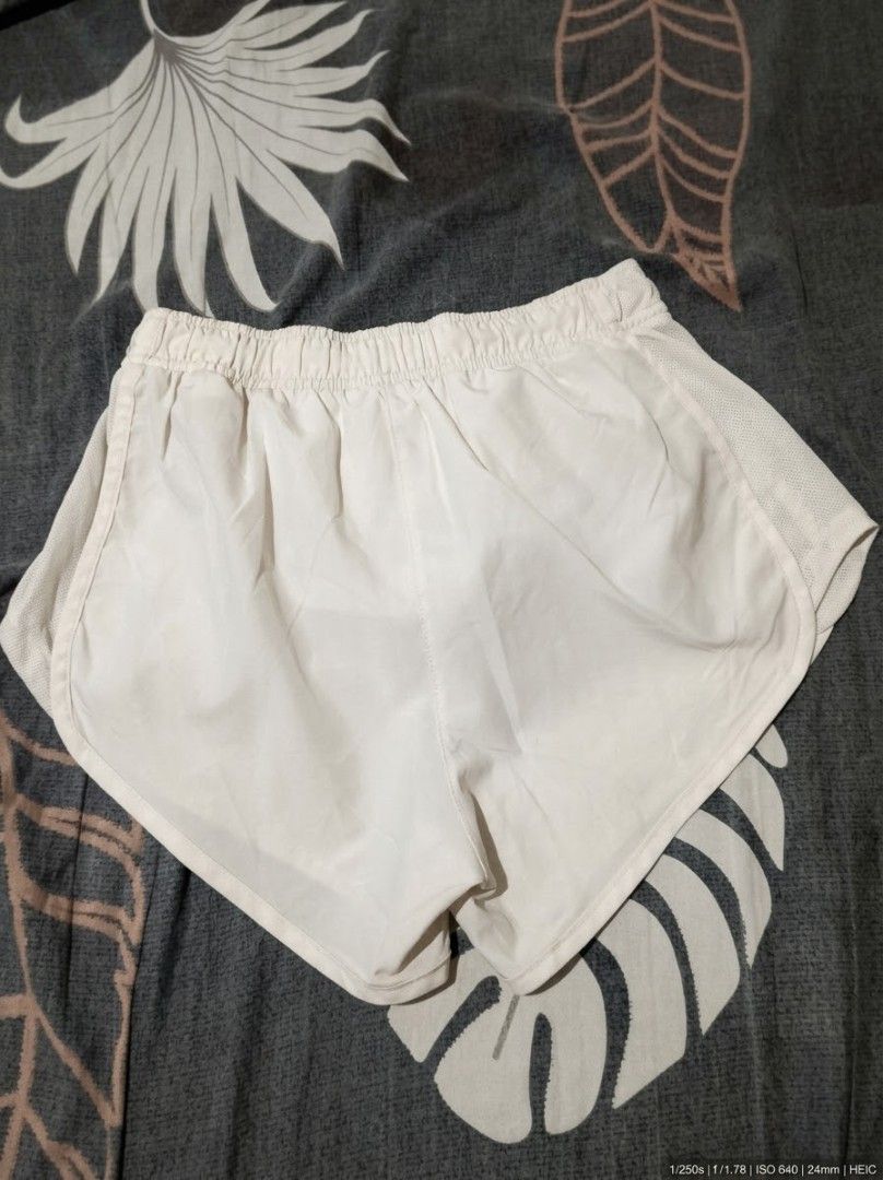 Nike Dri-FIT White Running Shorts (Category: Shorts) located in Urdaneta. Submitted by goldeneagle-e662 (Listing ID 1471199030, Image 2). Description: - Brand: Nike - Type: Running shorts - Color: White with classic silver Nike swoosh - Size: XS - Origin: Made in Malaysia - Material & Tech: Lightweight fabric with Dri-FIT technology - Features: Elastic waistband with adjustable drawstring, breathable mesh side panels - Condition: Clean and ready 