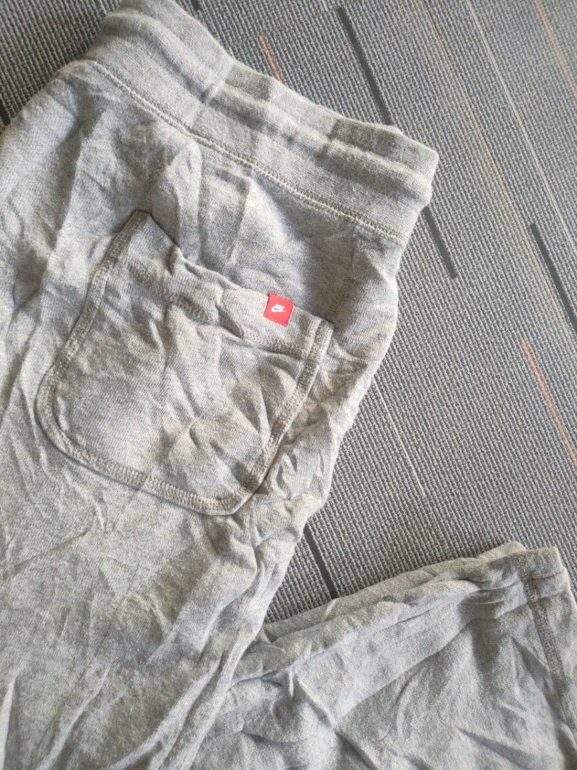 Nike Grey Joggers Sweatpants with Neon Yellow Drawstrings (Category: Joggers) located in Guimba. Submitted by kim-yran.001 (Listing ID 1471158258, Image 3). Description: - Brand: Nike - Material: Comfortable cotton fleece - Color: Grey with neon yellow accents - Features: Neon yellow drawstrings, matching neon logo embroidery, and ribbed ankle cuffs - Style: Great for everyday lounging, easily matched with hoodies and sneakers.