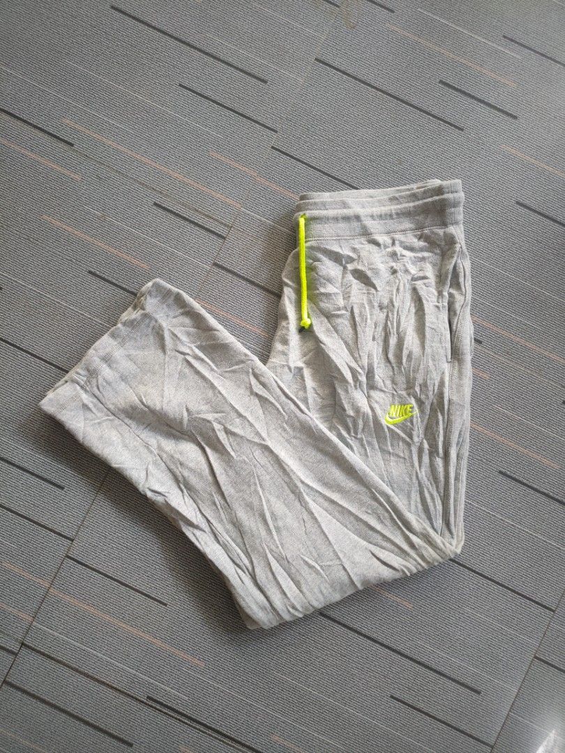Nike Grey Joggers Sweatpants with Neon Yellow Drawstrings (Category: Joggers) located in Guimba. Submitted by kim-yran.001 (Listing ID 1471158258, Image 2). Description: - Brand: Nike - Material: Comfortable cotton fleece - Color: Grey with neon yellow accents - Features: Neon yellow drawstrings, matching neon logo embroidery, and ribbed ankle cuffs - Style: Great for everyday lounging, easily matched with hoodies and sneakers.