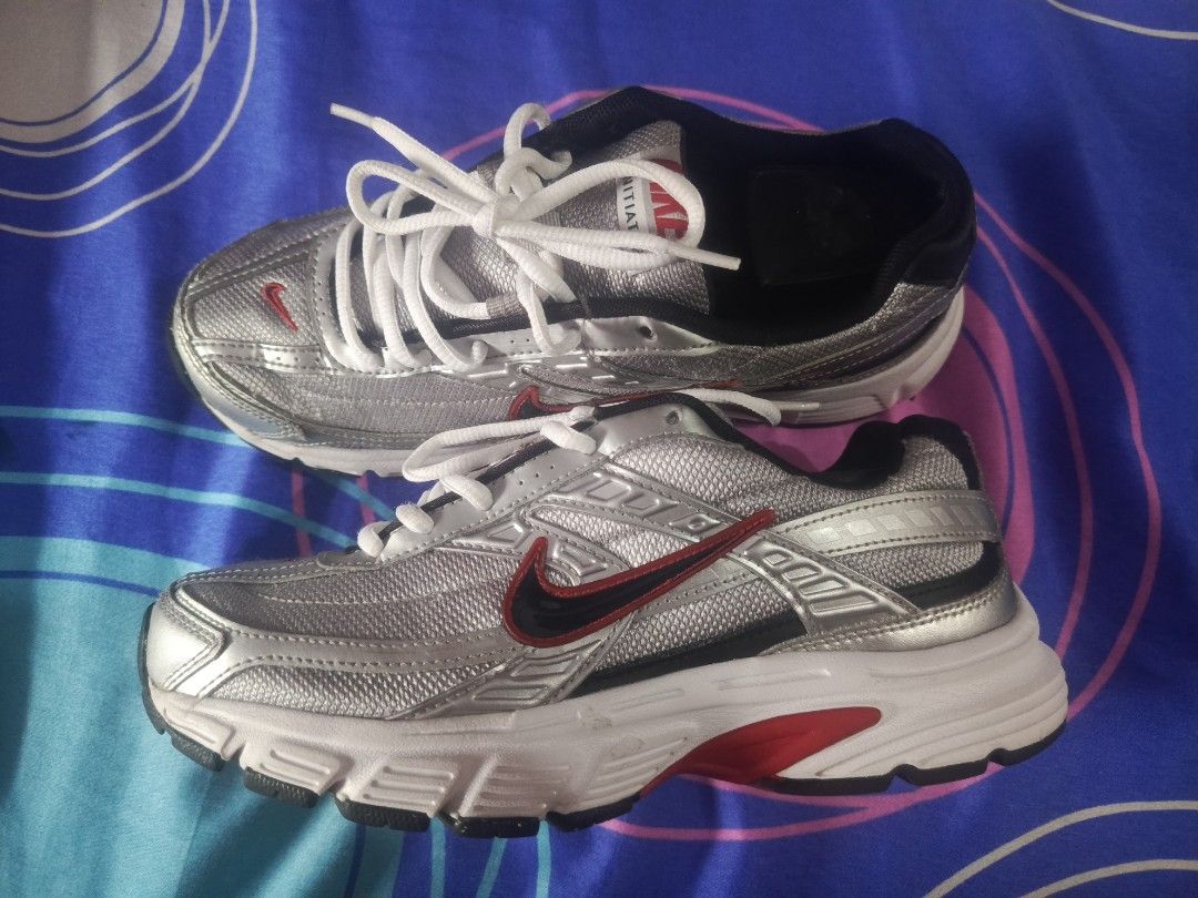 Nike Initiator Silver Red Running Shoes (Category: Sneakers) located in Pasig City. Submitted by atmclick (Listing ID 1471149794, Image 2). Description: - Brand: Nike - Model: Initiator - Colorway: Metallic Silver with Red and Black details - Features: Classic retro runner style, white laces, chunky white midsoles, comfortable fit for daily wear or workouts - Condition: Uppers are still clean, with normal signs of previous wear on the soles - Per