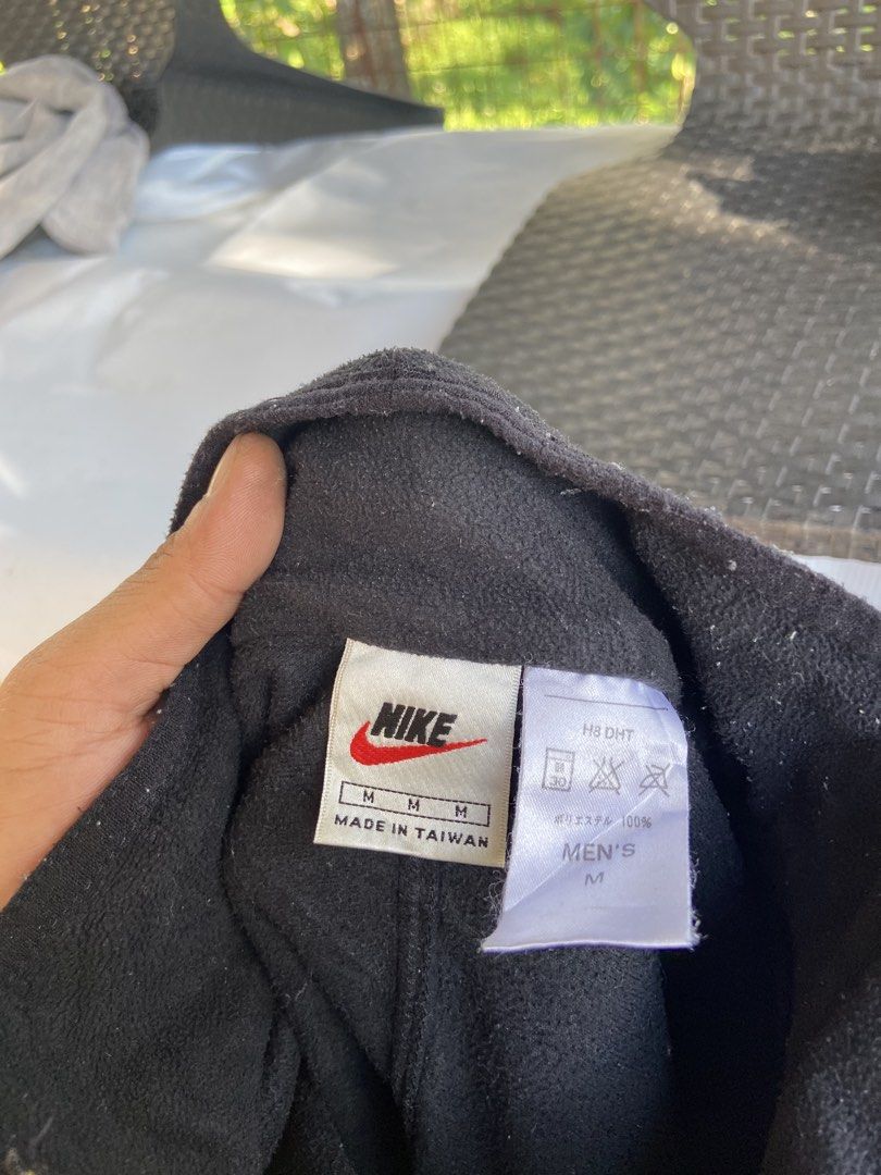 Nike Men's Black Fleece 1/4 Zip Pullover Size M (Category: Coats, Jackets and Outerwear) located in Manila. Submitted by koolash (Listing ID 1471135619, Image 2). Description: Black Nike fleece pullover with a half zip front. Small embroidered orange swoosh logo on the chest. Nike Fit branding near the bottom hem. 100 percent polyester material. Tag says men's size medium, made in Taiwan. Long sleeves with seam detailing..