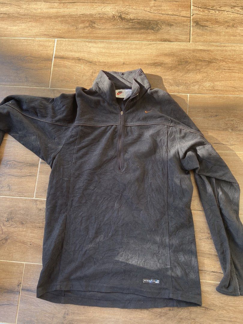 Nike Men's Black Fleece 1/4 Zip Pullover Size M (Category: Coats, Jackets and Outerwear) located in Manila. Submitted by koolash (Listing ID 1471135619, Image 3). Description: Black Nike fleece pullover with a half zip front. Small embroidered orange swoosh logo on the chest. Nike Fit branding near the bottom hem. 100 percent polyester material. Tag says men's size medium, made in Taiwan. Long sleeves with seam detailing..