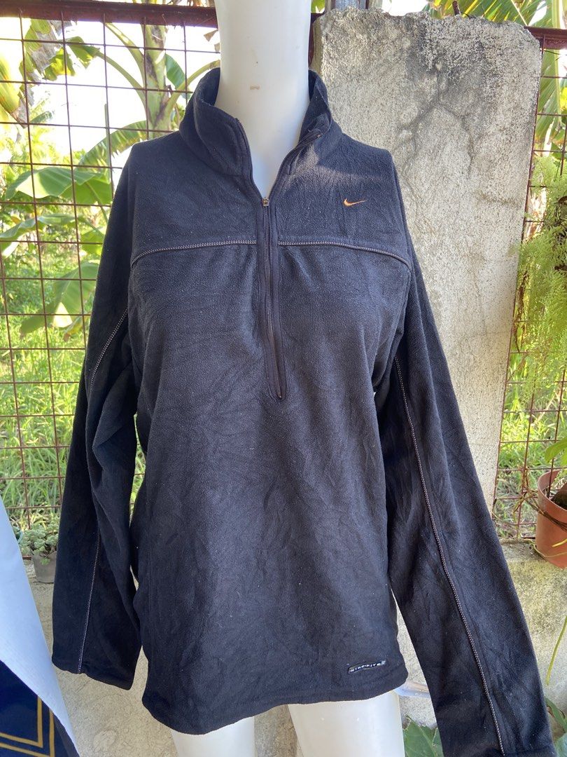 Nike Men's Black Fleece 1/4 Zip Pullover Size M (Category: Coats, Jackets and Outerwear) located in Manila. Submitted by koolash (Listing ID 1471135619, Image 1). Description: Black Nike fleece pullover with a half zip front. Small embroidered orange swoosh logo on the chest. Nike Fit branding near the bottom hem. 100 percent polyester material. Tag says men's size medium, made in Taiwan. Long sleeves with seam detailing..