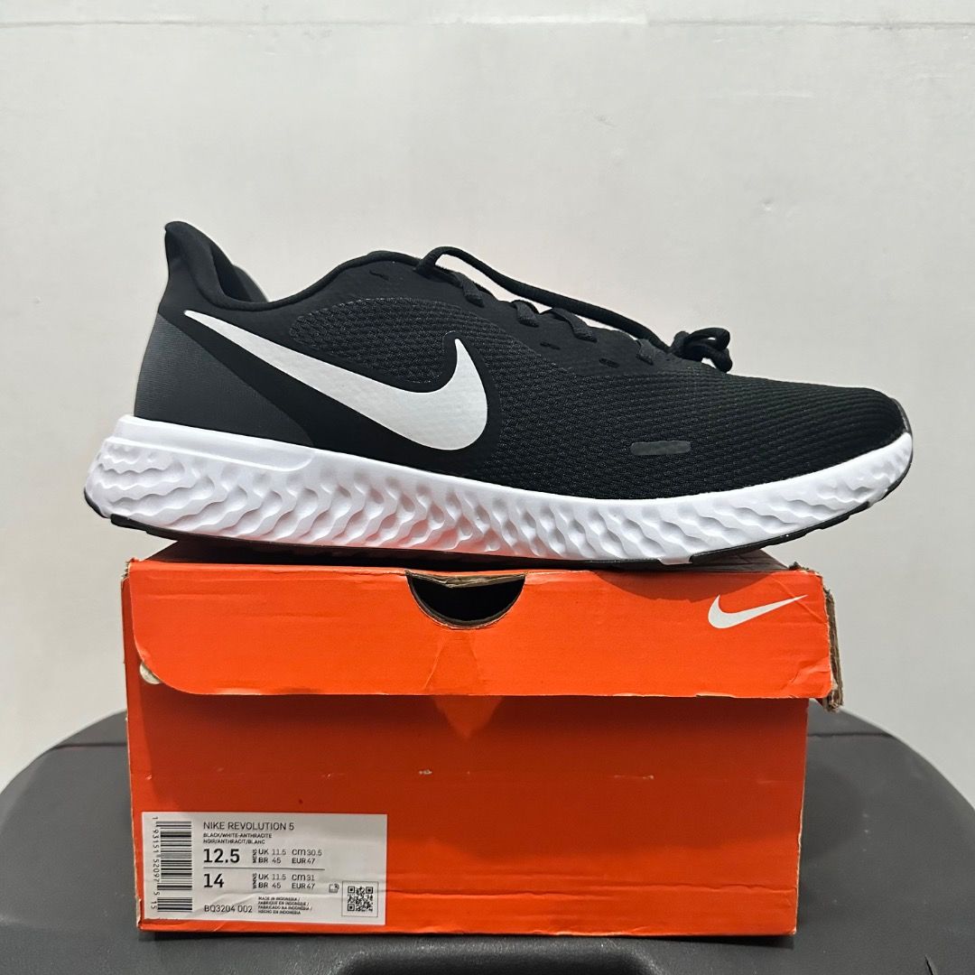 Nike Revolution 5 Black White Running Shoes (Category: Sneakers) located in Manila. Submitted by johnpm (Listing ID 1471239010, Image 1). Description: - Brand: Nike Revolution 5 - Color: Classic Black & White - Size: US 12.5 (Tag shows US 12.5 / 14) - Condition: Brand new, unworn, fresh out of the box - Features: Breathable mesh upper, cushioned foam midsole, durable rubber outsole - Inclusion: Complete with original Nike orange box.
