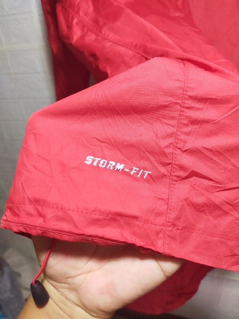 Nike Storm-Fit Red Running Jacket Size M (Category: Coats, Jackets and Outerwear) located in Valencia. Submitted by cabisaythriftshop (Listing ID 1471223279, Image 3). Description: - Brand: Nike - Model: Storm-Fit Jacket - Color: Vibrant Red - Size: Men's Medium (M) - Material: 100% polyester body, 80% polyester / 20% spandex mesh - Features: Full zip front, high collar, and reflective shoulder stripes for visibility - Performance: Excellent wind
