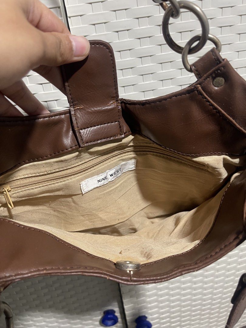 Nine West Brown Shoulder Bag (Category: Shoulder Bags) located in Manila. Submitted by mawiya.v (Listing ID 1471166314, Image 2). Description: bought this here on carousell but my ipad wont fit so benta ko na lang uli - Mode of Payment: BPI, GCash, - Shipping: Via J&T Express (Buyer shoulders shipping fee) or same-day delivery within Metro Manila.