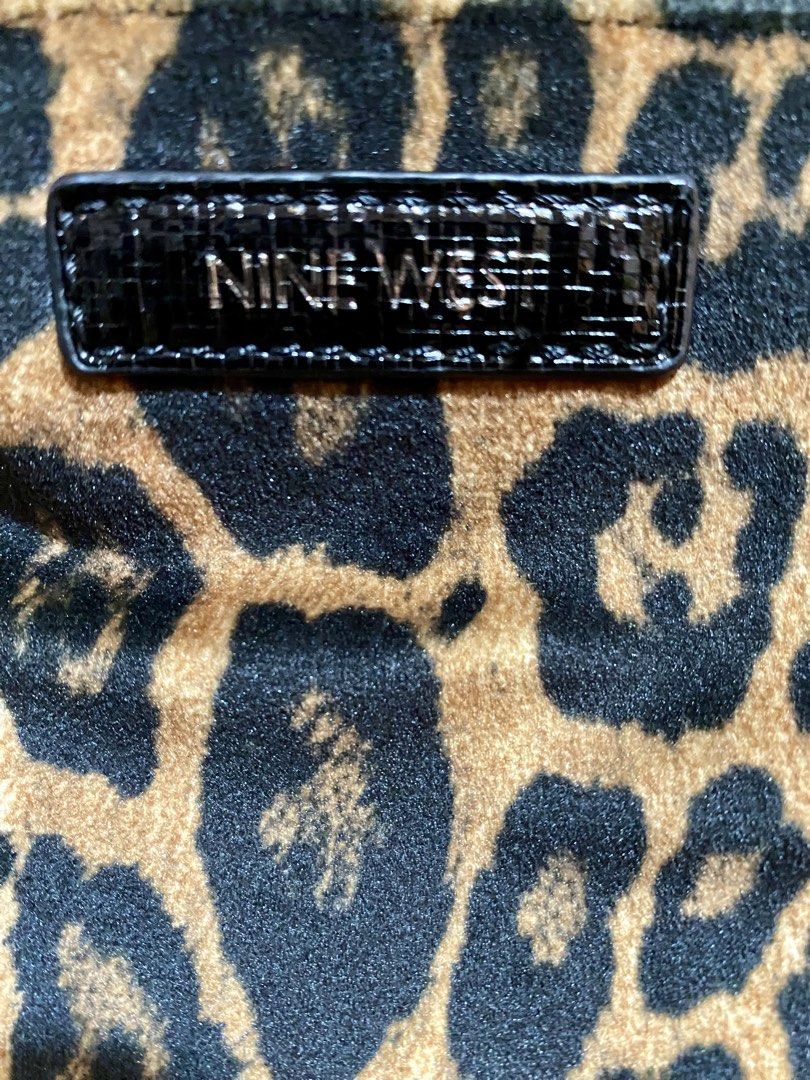Nine West Leopard Print Shoulder Bag (Category: Shoulder Bags) located in Manila. Submitted by kaiiila (Listing ID 1471208373, Image 2). Description: - Brand: Nine West - Pattern: Classic leopard print with black patent leather strap and trim - Material: Soft fabric - Closure: Top zip - Details: Rectangular branded badge on front, compact size.
