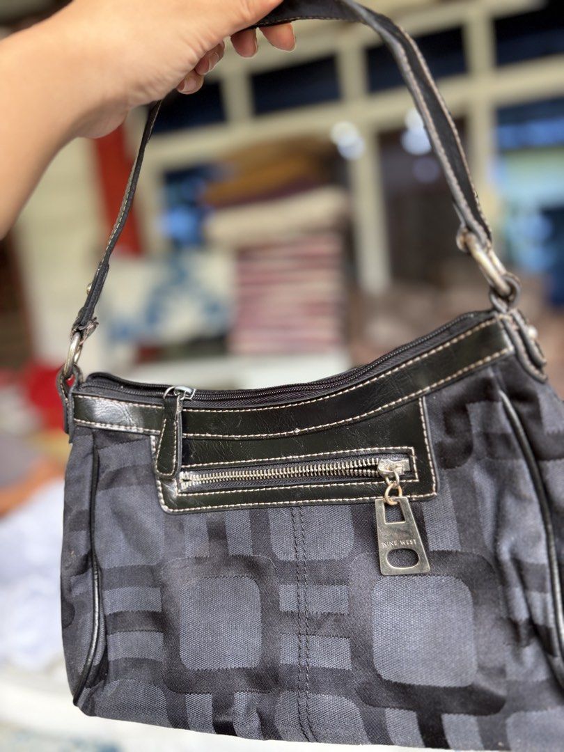 Nine West Monogram Geometric Shoulder Bag (Category: Shoulder Bags) located in Manila. Submitted by dorilorenr48954 (Listing ID 1471219454, Image 3). Description: - Brand: Authentic Nine West - Design: Black and grey geometric pattern with black faux leather trim - Closure: Secure top zip main compartment - Pockets: Exterior front zip pocket with branded pull tab + interior zip pocket - Interior: Fully lined in black fabric - Condition: Tagged wi