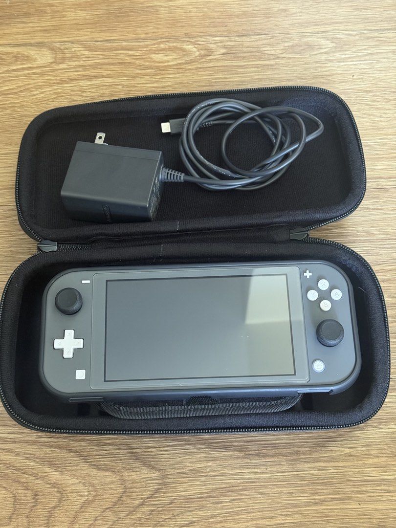 Nintendo Switch Lite Gray with Skull & Co Case and Charger (Category: Nintendo) located in Caloocan City. Submitted by lounarcisom (Listing ID 1471255815, Image 1). Description: - Item: Nintendo Switch Lite (Gray) - Condition: 10/10 - Original wall charger, and box - Black Skull & Co carrying case with secure zipper - Thumb Grip Skull & Co - Perfect for handheld gaming on the go - Protective case - Meetup or shipping options available (PM for det